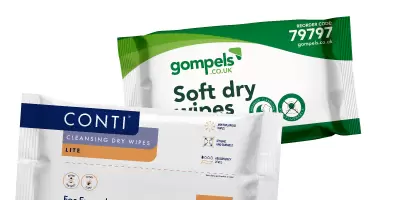 Packets of dry wipes next to a container of body wash