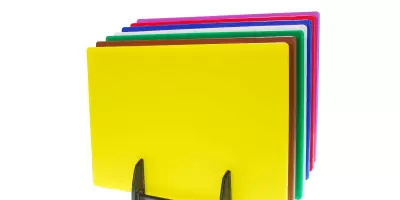 A set of 7 coloured chopping boards in their rack