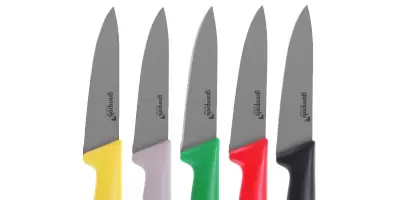 A set of large chefs knifes in a range of bright colours