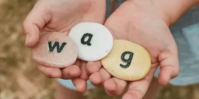 A boy holding literacy stones