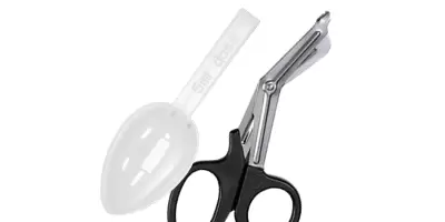 A pair of twezers next to some medical scissors