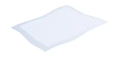 An absorbent bed pad unfolded and ready for use