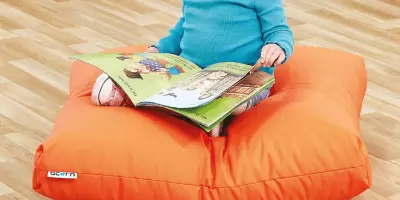 A wooden unit holding bright and colour cushions for children