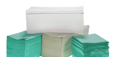 A bundle of paper towels in green white and natural