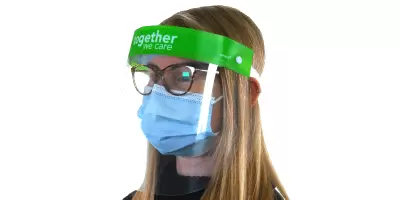A young lady wearing a face mask and visor