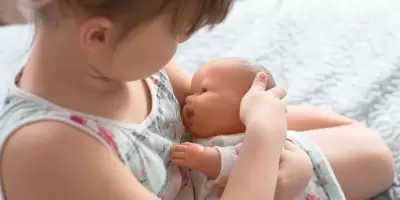 A girl holding a toy doll