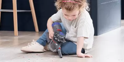 A girl playing with a toy dyson